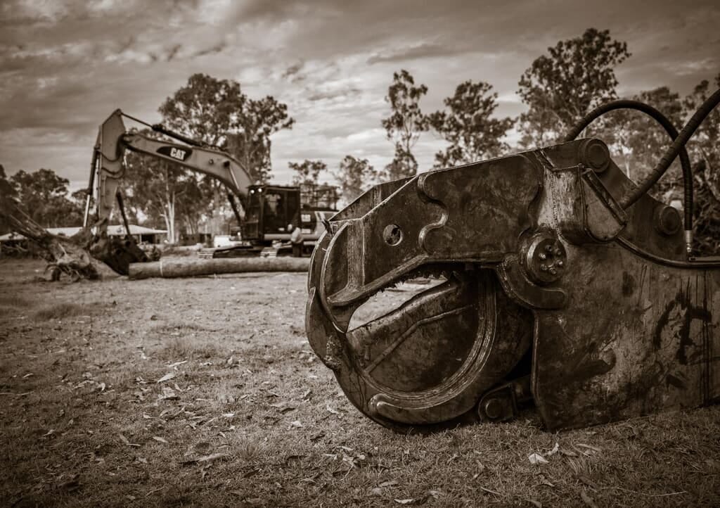 Chainsaw cutting through a felled log