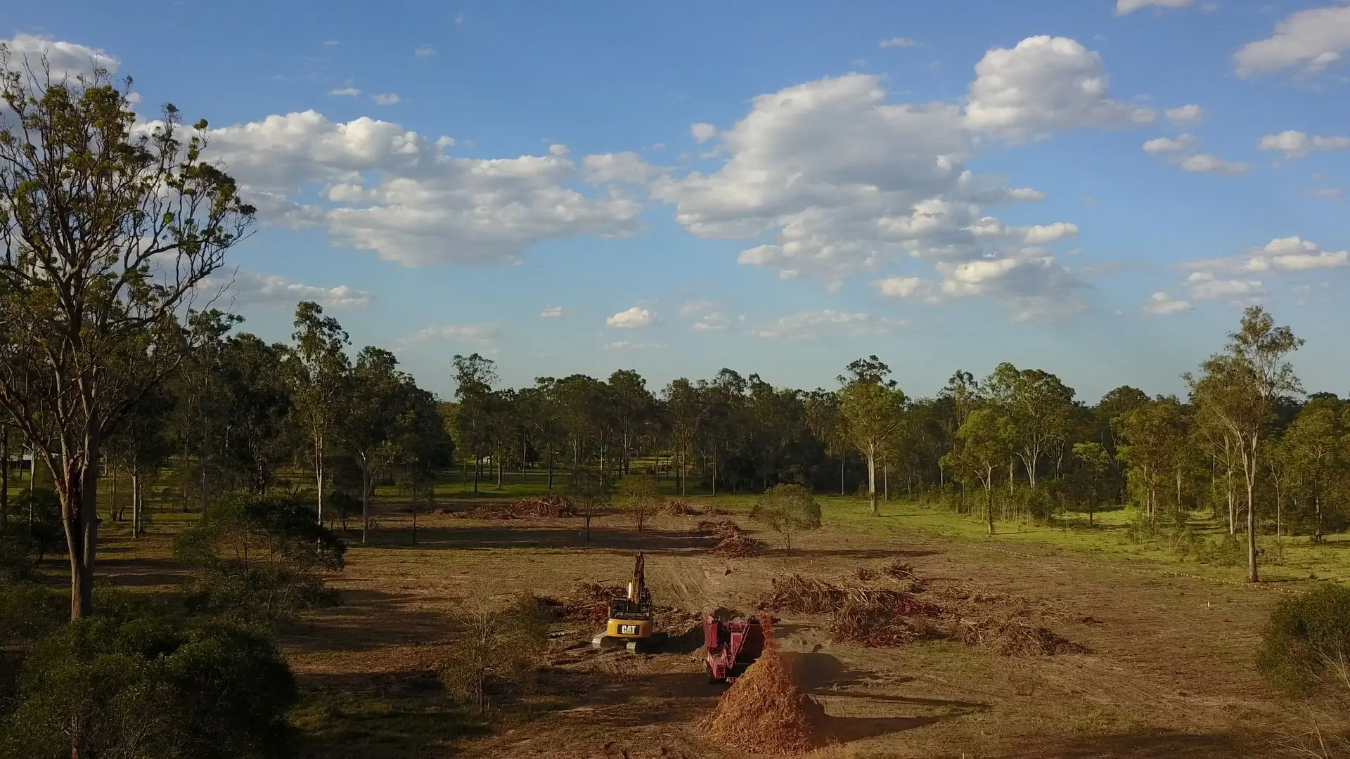 Aerial view of a development block cleared by Tree Eaters beside the road